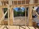 Framed opening with a view of a lake and trees during construction at 42 Ponchartrain St, Fuquay Varina, NC 27526