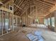 Interior framing of a house with blueprints in the foreground and lots of natural light at 42 Ponchartrain St, Fuquay Varina, NC 27526