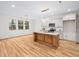 Modern kitchen featuring a center island, pendant lighting, and white cabinetry at 42 Ponchartrain St, Fuquay Varina, NC 27526