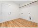 Laundry room with wood floors, bright white walls, a hanging rack, and utility connections at 42 Ponchartrain St, Fuquay Varina, NC 27526