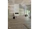 Open concept living area featuring hardwood floors and a fireplace at 42 Ponchartrain St, Fuquay Varina, NC 27526