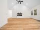 Living room with wood floors, a modern electric fireplace, vaulted ceilings, and a ceiling fan at 42 Ponchartrain St, Fuquay Varina, NC 27526