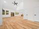 Open living room with a vaulted ceiling, a ceiling fan, and light wood flooring at 42 Ponchartrain St, Fuquay Varina, NC 27526