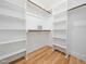 Walk-in closet featuring wood floors and custom shelving for optimal storage at 42 Ponchartrain St, Fuquay Varina, NC 27526