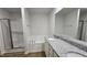 Bathroom featuring double sinks with granite countertop, soaking tub, and separate shower with glass door at 427 Magnolia Run Way, Benson, NC 27504