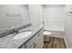 This bathroom has a single sink vanity with a granite countertop and a tub shower at 427 Magnolia Run Way, Benson, NC 27504