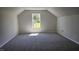 This bedroom has neutral colored walls and carpet with a window looking to the exterior at 427 Magnolia Run Way, Benson, NC 27504