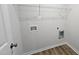 A white laundry room includes hookups for a washer, dryer, and wire shelving at 427 Magnolia Run Way, Benson, NC 27504