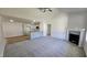 Bright living room features a fireplace, vaulted ceiling, and seamless transition to the modern kitchen at 427 Magnolia Run Way, Benson, NC 27504