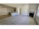 Bright living room featuring a fireplace, vaulted ceiling, and seamless transition to the modern kitchen at 427 Magnolia Run Way, Benson, NC 27504