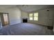 Inviting living room boasts a cozy fireplace, large windows, and a ceiling fan for added comfort at 427 Magnolia Run Way, Benson, NC 27504