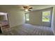 Spacious main bedroom featuring plush carpeting, ample natural light, and an ensuite bathroom for added convenience at 427 Magnolia Run Way, Benson, NC 27504