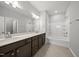 A spacious bathroom features a double vanity, soaking tub, and modern fixtures at 43 Pansy Park # 233, Clayton, NC 27520