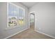Light streams in through the window in this carpeted, neutral-colored bedroom at 43 Pansy Park # 233, Clayton, NC 27520