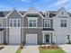 Charming townhomes with gray and white siding, attached garages, and well-maintained landscaping at 43 Pansy Park # 233, Clayton, NC 27520