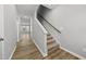 Hallway with wood-look flooring leading to stairs with carpet and neutral walls at 43 Pansy Park # 233, Clayton, NC 27520