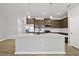 Open kitchen with an island, modern appliances, and ample counter space at 43 Pansy Park # 233, Clayton, NC 27520