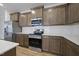 Kitchen featuring stainless steel appliances, wood cabinets, white countertops and backsplash at 43 Pansy Park # 233, Clayton, NC 27520