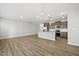 Open kitchen features a center island, stainless appliances, and hardwood floors at 43 Pansy Park # 233, Clayton, NC 27520