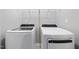 Laundry room includes a washer and dryer, overhead wire shelving for storage at 43 Pansy Park # 233, Clayton, NC 27520
