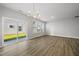 Bright dining room with a modern chandelier and sliding glass door at 43 Pansy Park # 233, Clayton, NC 27520