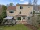 Two-story home featuring a wood deck with pergola and large windows, with a brick paver landing at 4318 Peachway Dr, Durham, NC 27705