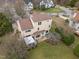 Aerial view of the two-story home highlighting the backyard, deck with pergola, and the surrounding neighborhood at 4318 Peachway Dr, Durham, NC 27705