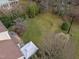 An aerial view of the backyard reveals a spacious lawn, mature trees and landscaping at 4318 Peachway Dr, Durham, NC 27705