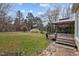 Backyard showing a deck and lawn, plus trees and perimeter fencing at 4318 Peachway Dr, Durham, NC 27705
