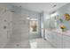Bathroom featuring a large walk-in shower, white vanity, and light blue walls with nautical accents at 4318 Peachway Dr, Durham, NC 27705