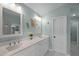 Bright bathroom with a double sink vanity, modern fixtures, and ocean-themed decor at 4318 Peachway Dr, Durham, NC 27705