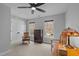 Bedroom with carpet, two windows, a ceiling fan, and charming vintage furnishings at 4318 Peachway Dr, Durham, NC 27705