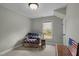 Comfortable bedroom nook featuring a cozy chair, side table, and natural lighting at 4318 Peachway Dr, Durham, NC 27705