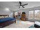 Carpeted bedroom featuring a ceiling fan, dresser, and windows overlooking the outdoors at 4318 Peachway Dr, Durham, NC 27705