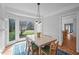 Bright dining room with bay window, wainscoting, and stylish pendant lighting above dining table at 4318 Peachway Dr, Durham, NC 27705