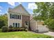 Charming two-story home featuring a brick facade, dormer, attached two-car garage, and landscaped front yard at 4318 Peachway Dr, Durham, NC 27705