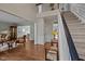 Inviting foyer with hardwood floors, a staircase, and views into the living and dining areas at 4318 Peachway Dr, Durham, NC 27705