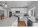Bright kitchen featuring white cabinets, stainless steel appliances, granite counters, and hardwood floors at 4318 Peachway Dr, Durham, NC 27705
