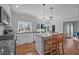 Modern kitchen featuring white cabinets, stainless steel appliances, and an island with seating at 4318 Peachway Dr, Durham, NC 27705
