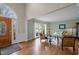 Bright living room with hardwood floors, large windows, and an elegant front door entrance at 4318 Peachway Dr, Durham, NC 27705