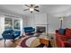 Comfortable living room with a fireplace, colorful rug, and sliding glass doors to the backyard at 4318 Peachway Dr, Durham, NC 27705