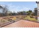 Wood deck overlooking a backyard with manicured lawn, mature trees, and neighborhood views at 437 Creekhurst Pl, Cary, NC 27519