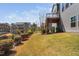 Exterior landscape of backyard with green lawn and colorful bushes lining the fence at 437 Creekhurst Pl, Cary, NC 27519