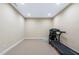 Basement gym with carpet flooring featuring a treadmill, great for a workout at 437 Creekhurst Pl, Cary, NC 27519