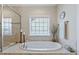 Luxurious soaking tub with a large window at 437 Creekhurst Pl, Cary, NC 27519