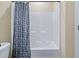 Bathroom features a white shower-tub combo with a blue-patterned curtain at 437 Creekhurst Pl, Cary, NC 27519