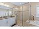 Luxurious bathroom featuring a glass-enclosed shower and a soaking tub at 437 Creekhurst Pl, Cary, NC 27519