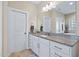 Well-lit bathroom with granite countertops, vanity, and a large mirror at 437 Creekhurst Pl, Cary, NC 27519