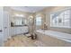 Spacious bathroom boasts a soaking tub, walk-in shower, and stylish tile flooring at 437 Creekhurst Pl, Cary, NC 27519