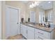 Bright bathroom featuring granite countertops, white cabinets, and ample storage space at 437 Creekhurst Pl, Cary, NC 27519